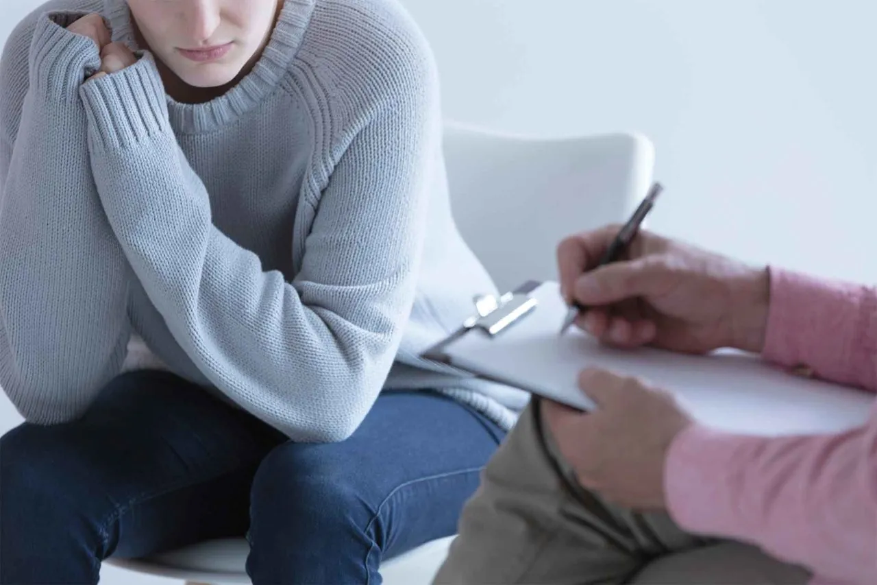 A victim advocate offering support and information to a client