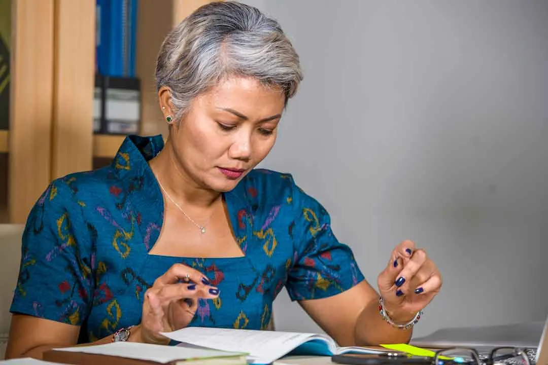 A victim advocate reviewing case paperwork at her desk