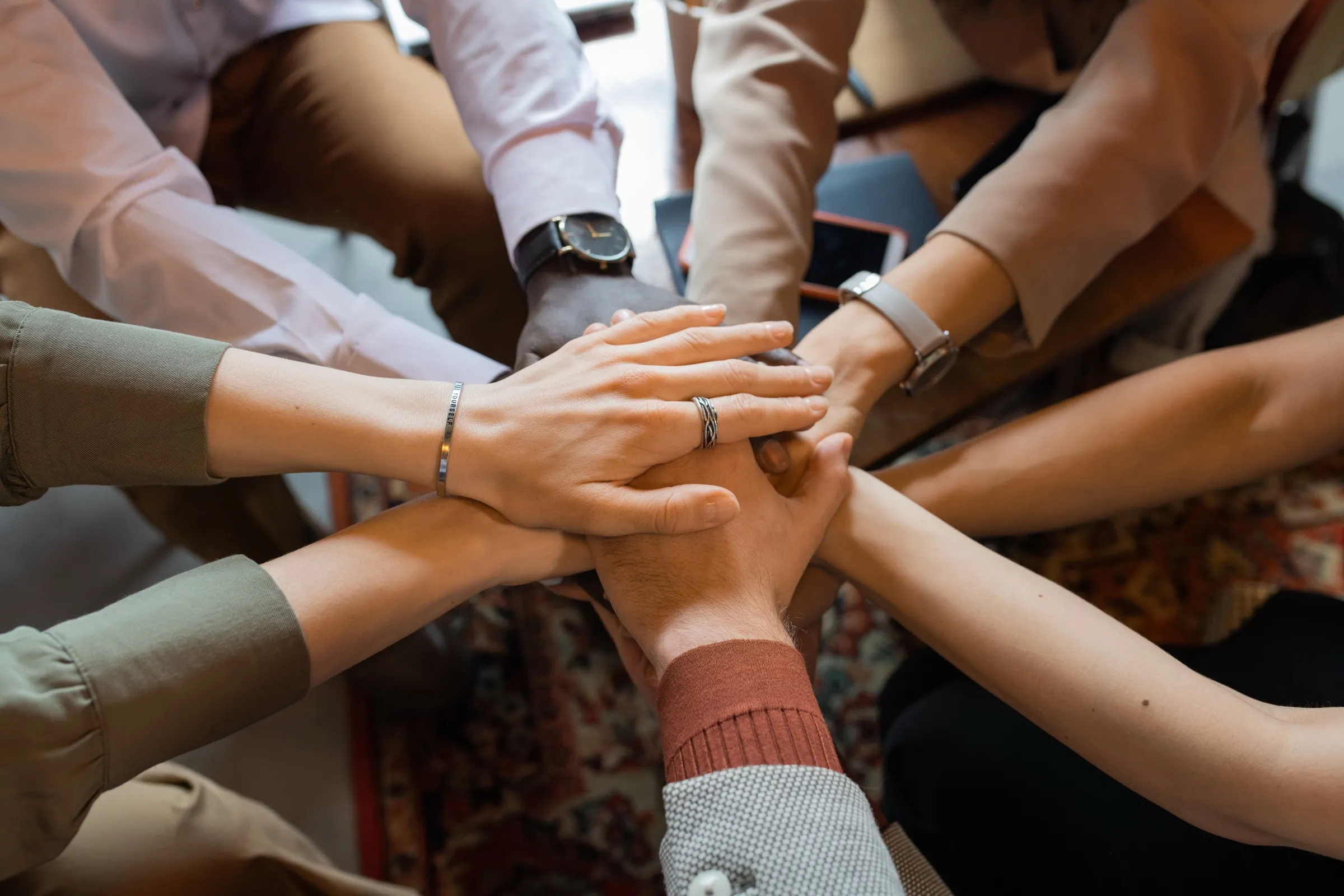 Colleagues joining hands in a circle